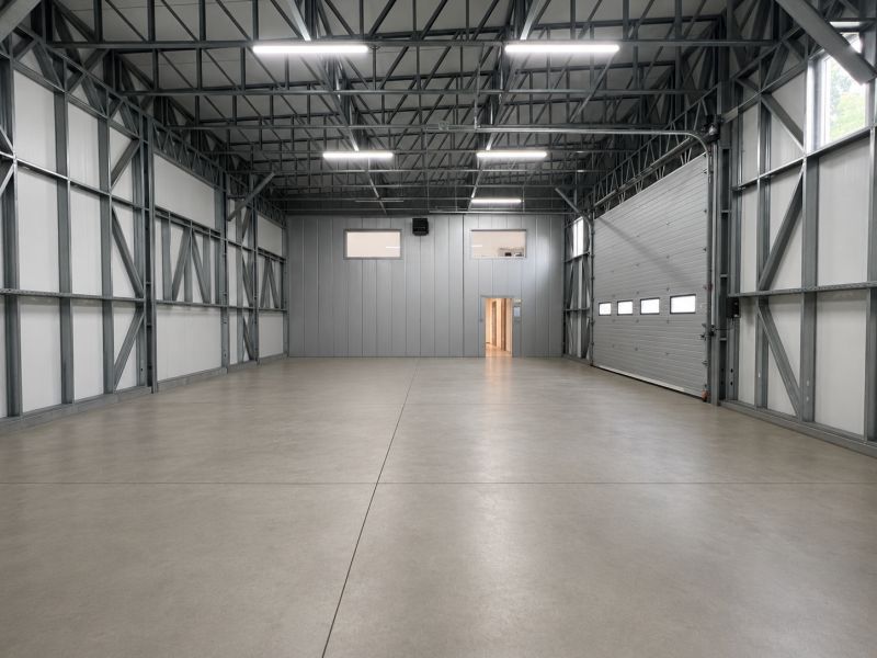 Production premises with a steel structure, concrete floor, and large entrance doors.