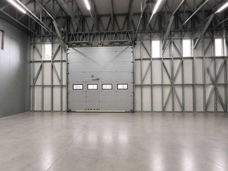 Spacious production facilities with concrete floors and steel structures.