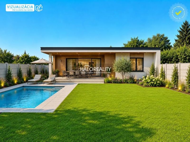 A pool and a terrace with loungers in the garden of the property in Juri nad Hronom.