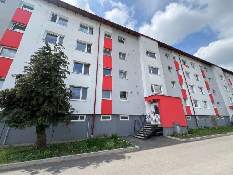 Apartment building on Za Nožiarňou Street, Slovenská Ľupča, with distinctive red panels.