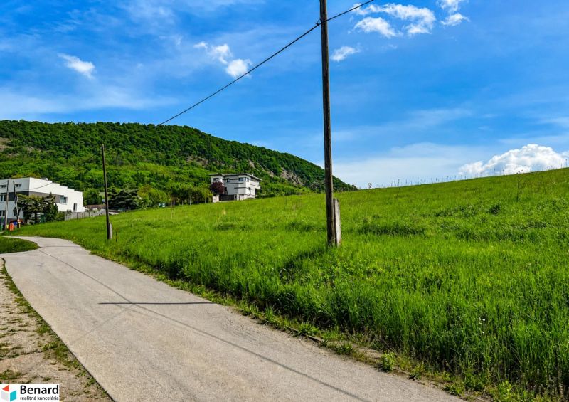 Hilly landscape near Fintice with residential plots and countryside in the background.