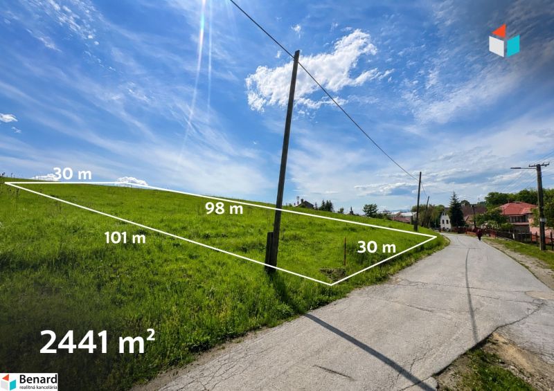 Lands - housing in Fintice with an area of 2441 m², next to the road under the blue sky.