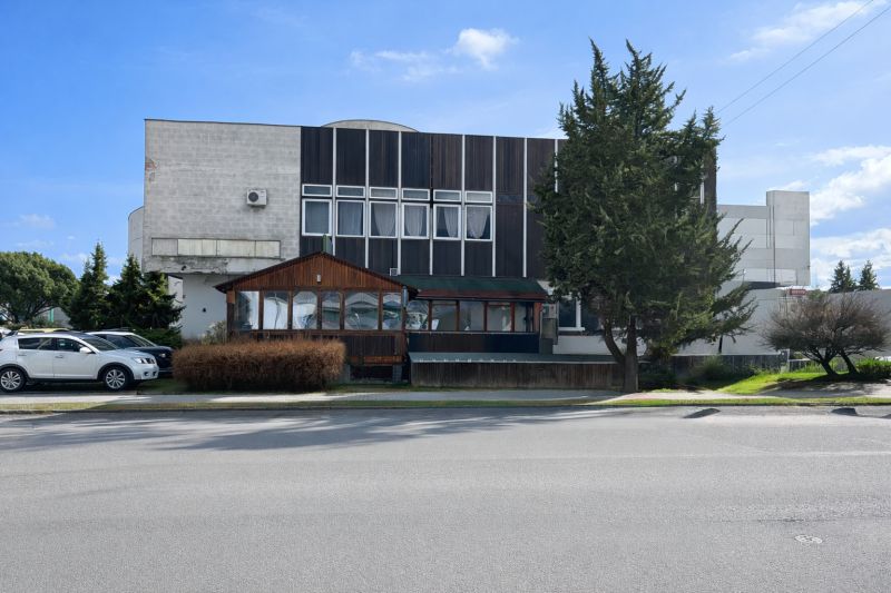 The exterior of the gastro premises in Žiar nad Hronom, surrounded by trees and parked cars.