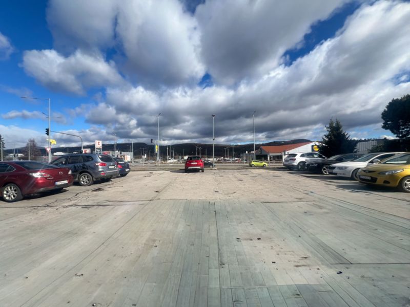 Parking lot with cars and cloudy sky in Žiar nad Hronom, Žiar nad Hronom District.