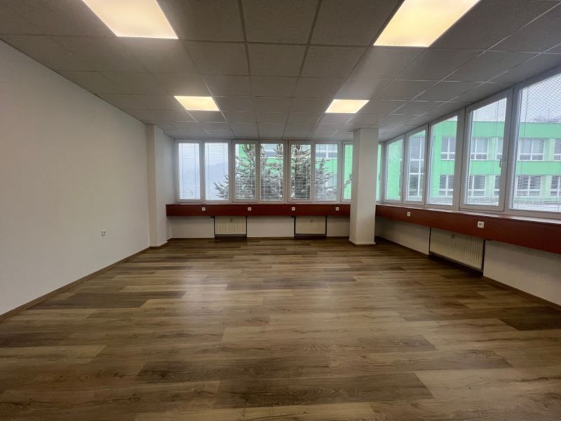 Offices with wood-patterned flooring and large windows, Banská Bystrica.