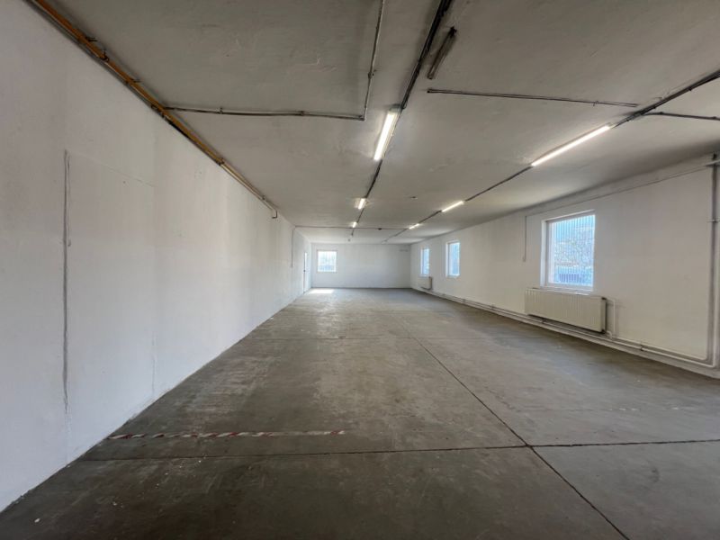 A large empty hall with a concrete floor in the building Warehouses and Halls.
