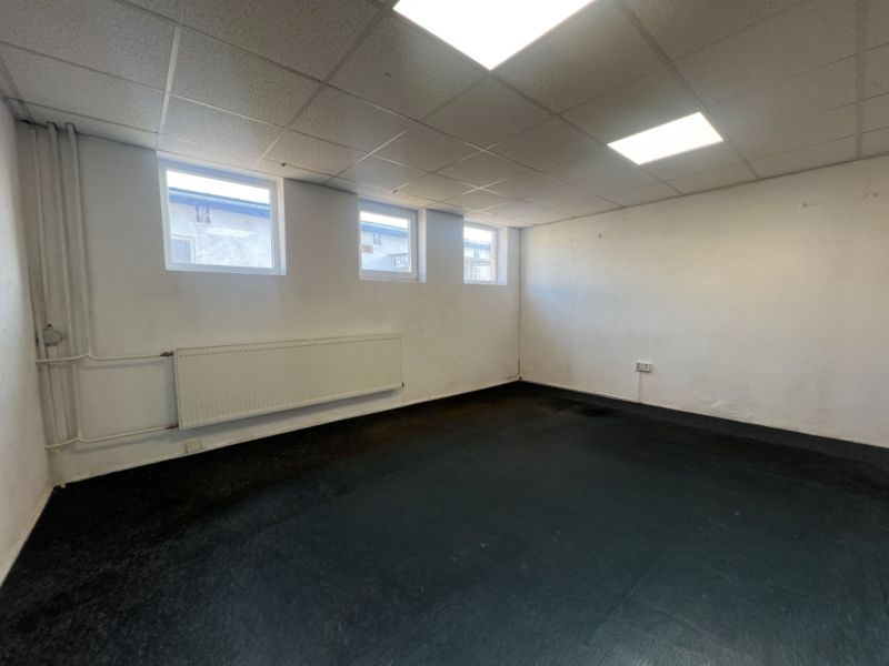 A room with a lowered ceiling, three windows, and a radiator in Warehouses and Halls.