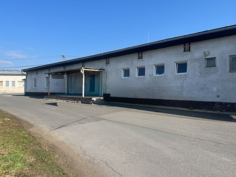 Warehouses and halls in the Banská Bystrica district, a concrete building on the road.