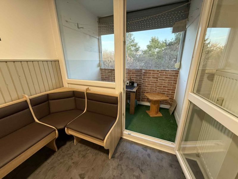 A bright loggia of a 4-room apartment with a view and wooden furniture.