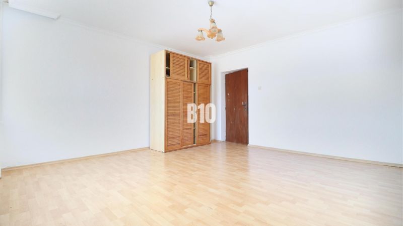 Interior with a wooden cabinet and floor with wooden decor in a family house.