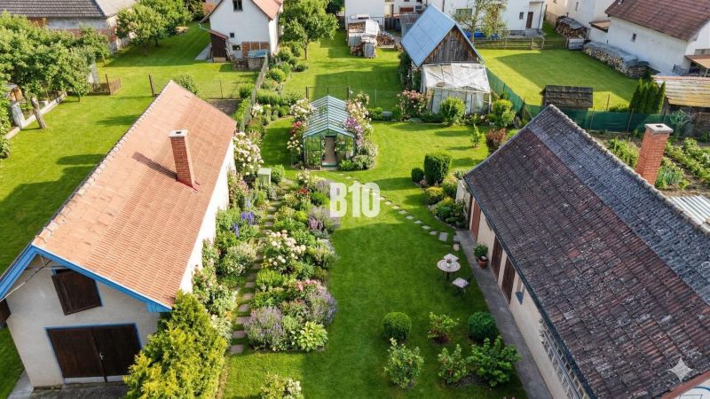 Aerial view of a garden at a family house in Turany, with a lawn and a gazebo.