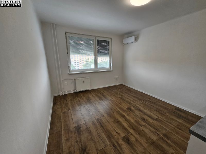 A studio apartment with air conditioning and a wooden decor floor offers a bright and cozy space.