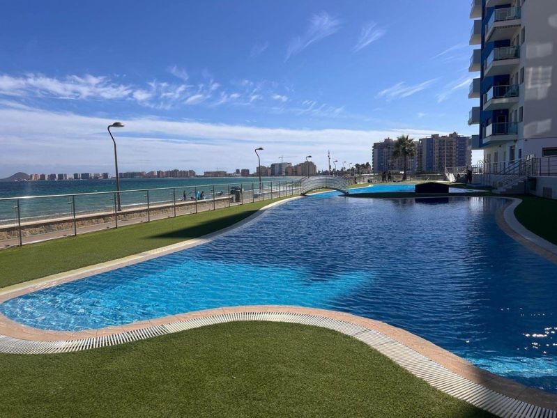 A pool with a sea view at the Holiday Apartment in La Manga del Mar Menor, Spain.