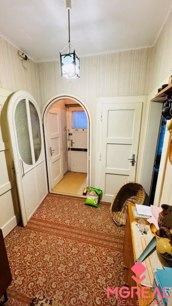 Carpeted floor, doors, and decorations in the interior of a 3-room apartment.