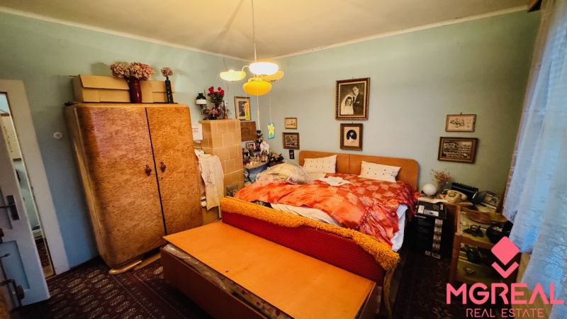 A bedroom in a 3-room apartment with vintage furniture and decor.