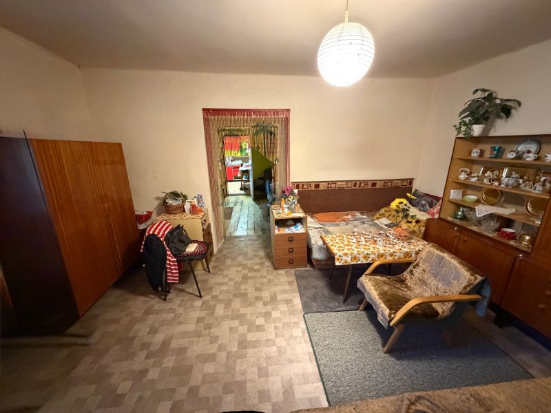 Living room in a family house with antique furniture and armchairs, floor with wooden decor.