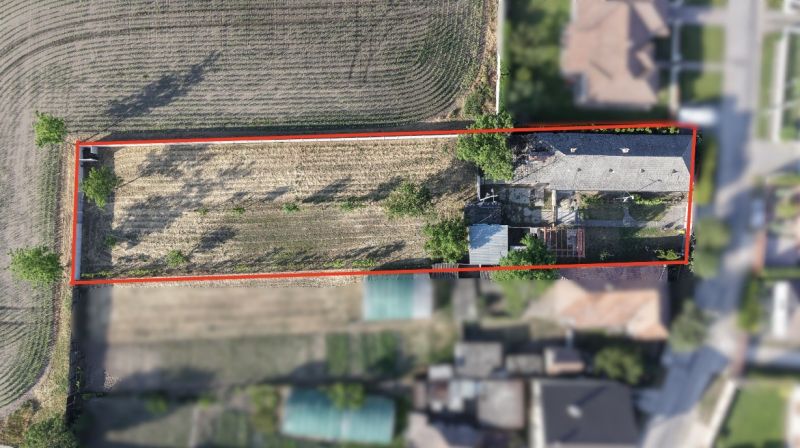 Aerial view of a family house complex in Nesvady with an adjacent plot of land.