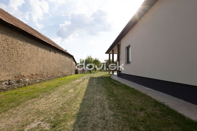 A view of the backyard of a family house in Zemplínska Široká with grass cover.