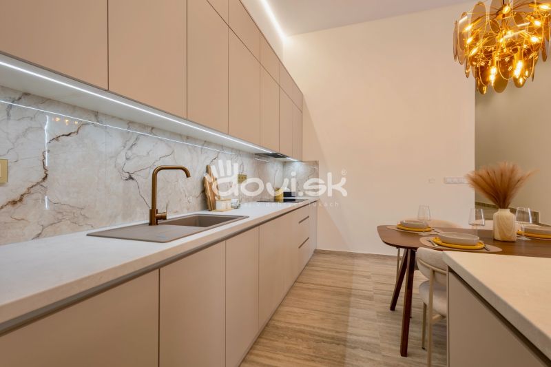 A kitchen with an elegant countertop, modern sink, and decorative lighting in a family house.
