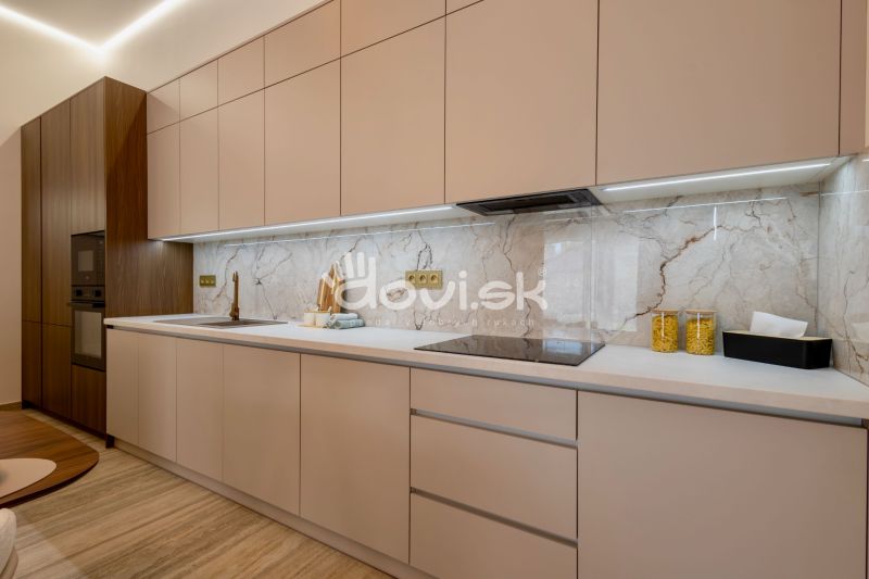 A kitchen in a family house with wooden decor and marble tiles.
