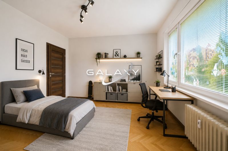 A bedroom with a bed, a desk, and a wooden decor floor in a 3-room apartment.