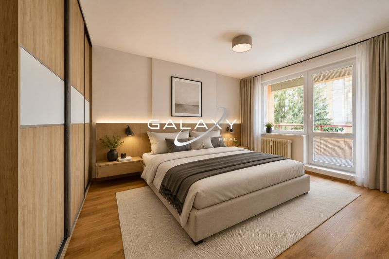 A bedroom in a three-room apartment with a bed, a large window, and a floor with a wooden decor.