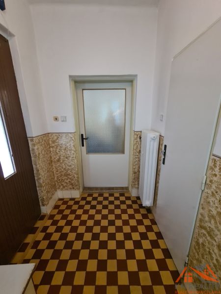 Tiling with a checkerboard pattern in the interior of a family house with white walls.