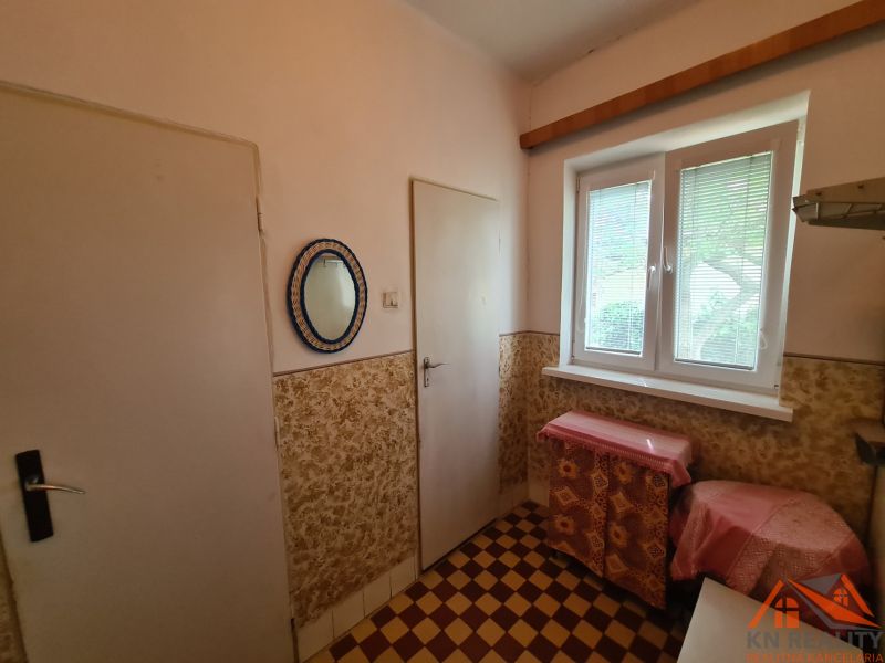 Interior in a family house with a tiled floor and a window with blinds.
