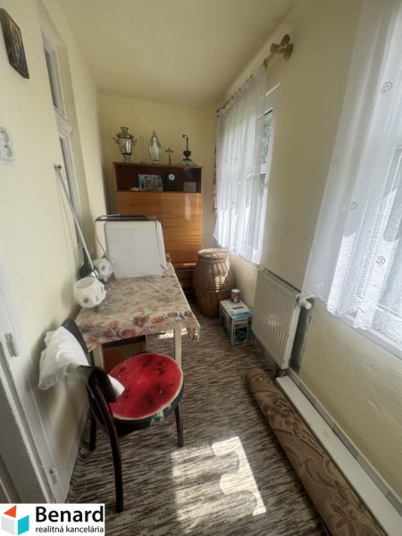 Room in a family house with carpet, furniture, and decorations.