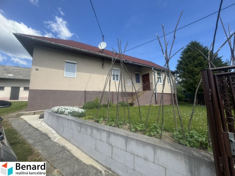 A family house in Orlov with a red roof and a fenced garden.