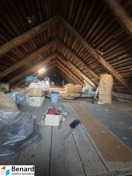 The attic of a family house filled with various items, including cardboard boxes.