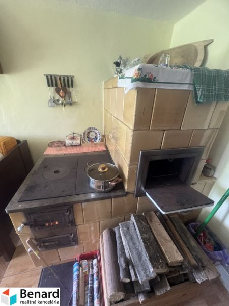Traditional solid fuel kitchen stove in a family house with rustic decor.