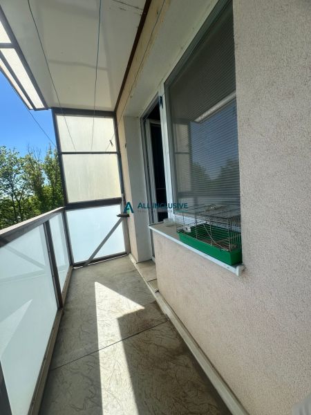 A balcony with tiles and railing in a 2-room apartment.