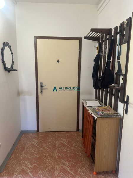 The entrance hall in a 2-room apartment with a coat rack and a shoe cabinet.