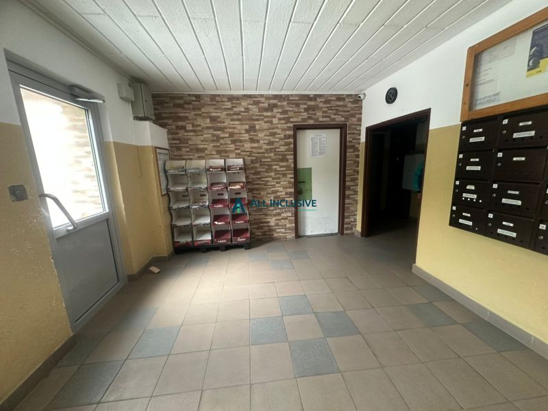 Entrance hallway of an apartment building with tiles and mailboxes, in a 2-room apartment.