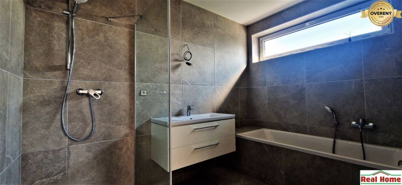 A bathroom with a shower and a bathtub in a 4-room apartment.