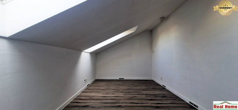Attic room with wooden decor flooring in a family house.