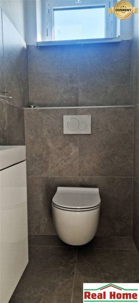 A toilet with ceramic tiles in a family house.