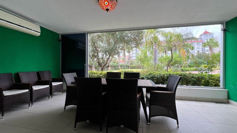 Unique properties with a terrace, rattan furniture, and a garden view.
