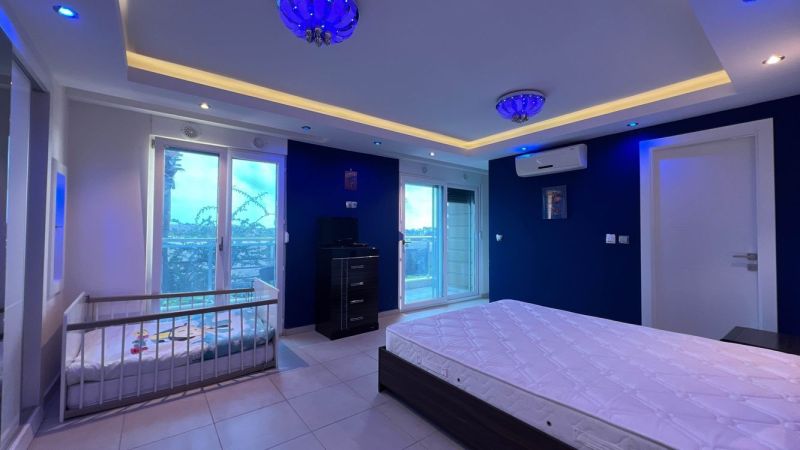 Interior with pendant lighting, a bed, and a crib in Unusual Properties.