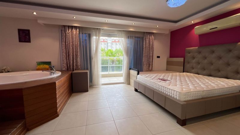 A bedroom with a built-in hot tub, bed, and balcony, Unique properties.