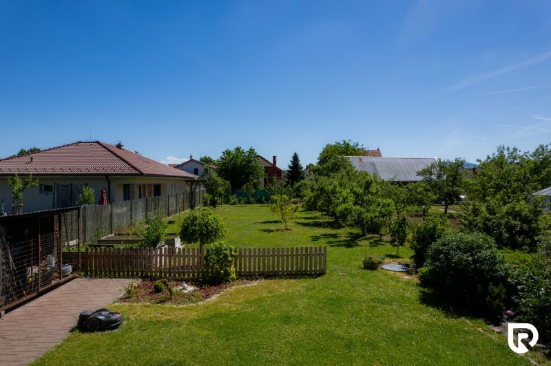 A grassy garden at a family house on Jahodova Street in Trencin with fruit trees.
