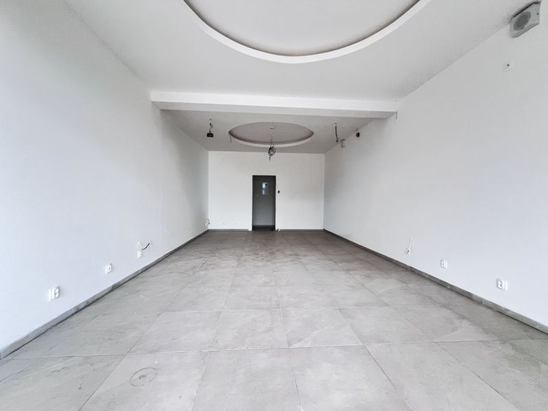Empty commercial spaces with white walls and ceramic tile flooring.