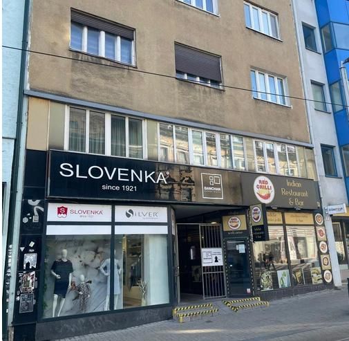 The building on Obchodná Street in Bratislava - Old Town with shops and a restaurant.