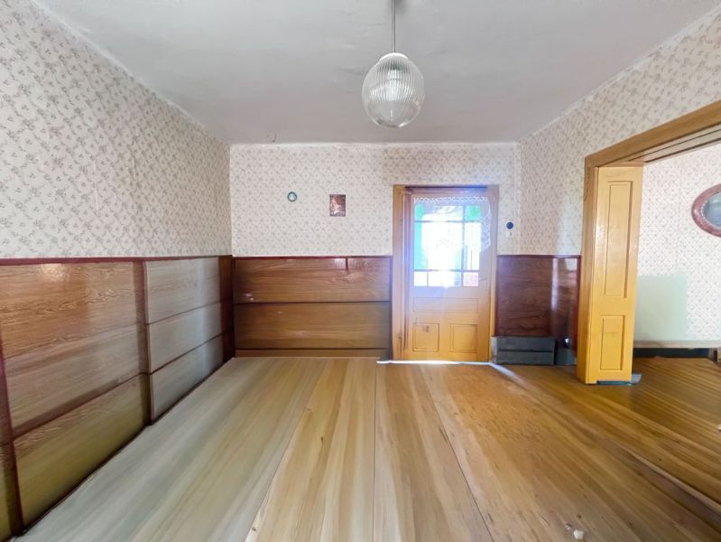 Interior of a family house with wooden doors, wooden paneling, and flooring with a wooden decor.