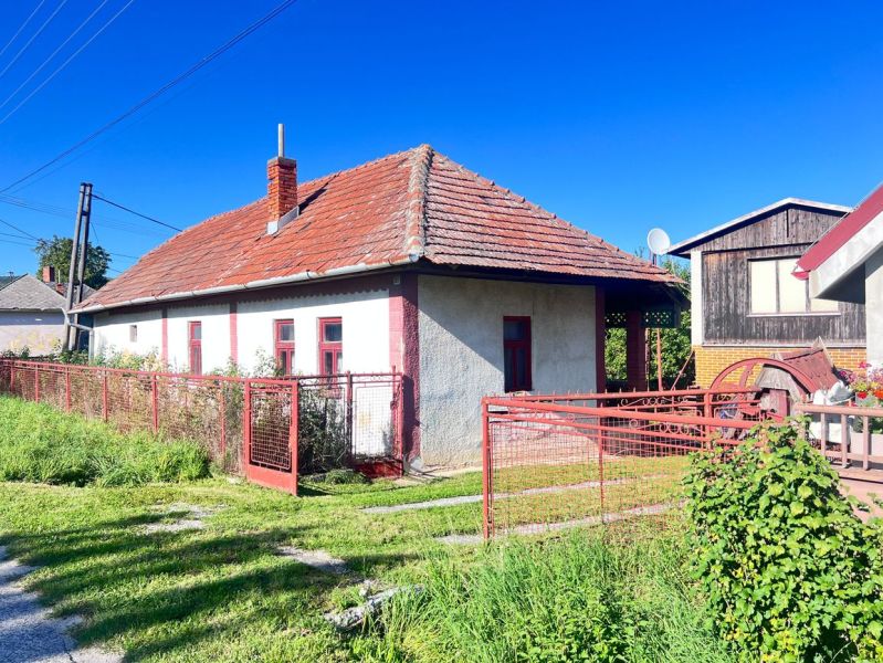 A family house in Žirany, Nitra district, with a red roof and fence.