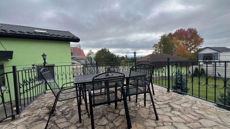 Terrace of the villa in Štôla, Poprad district, Prešov region, with a table and metal chairs.