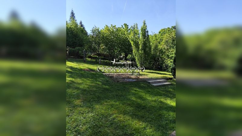 A garden at a family house in Horné Otrokovce, green lawn and fruit trees.