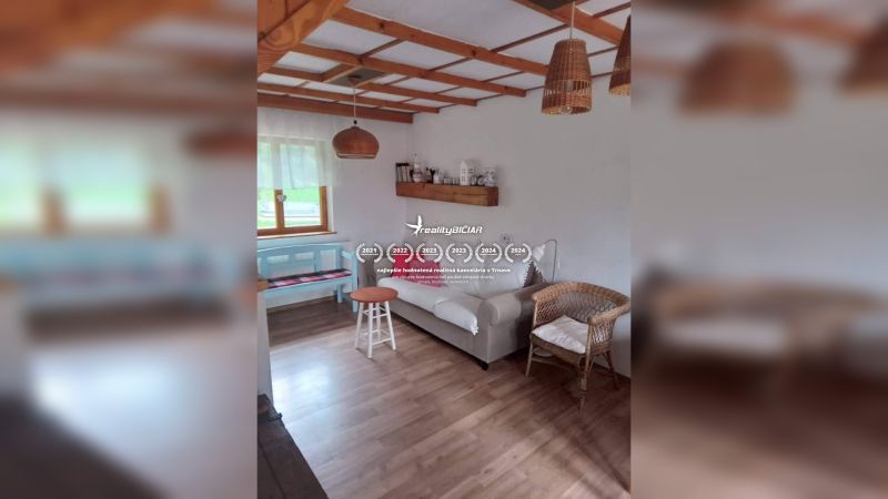 Interior in a family house with a wooden decor floor, rattan chair, and sofa.