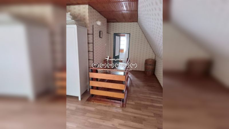 Attic room with wooden decor flooring in a family house.